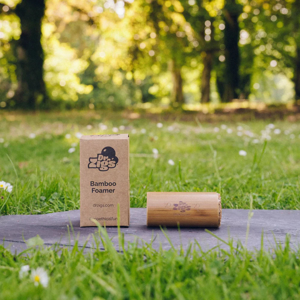 Bamboo foamer and packaging on a wooden surface with a natural background