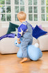 Child sitting on a blue bunny-shaped inflatable toy in a living room.