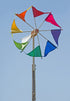 Colorful windmill with triangular flags against a clear blue sky