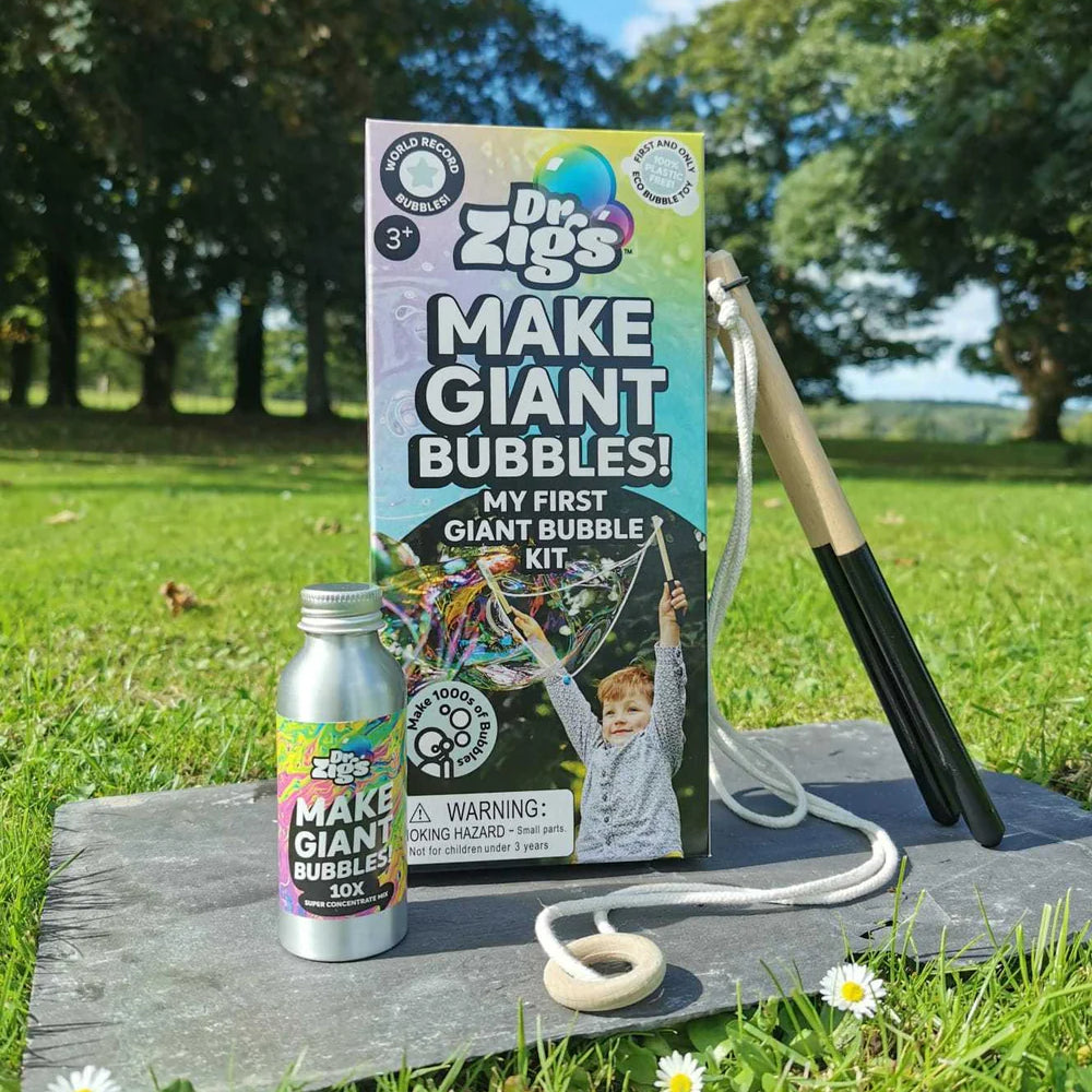 Dr. Zigs bubble kit with bottle and wand on a wooden board outdoors