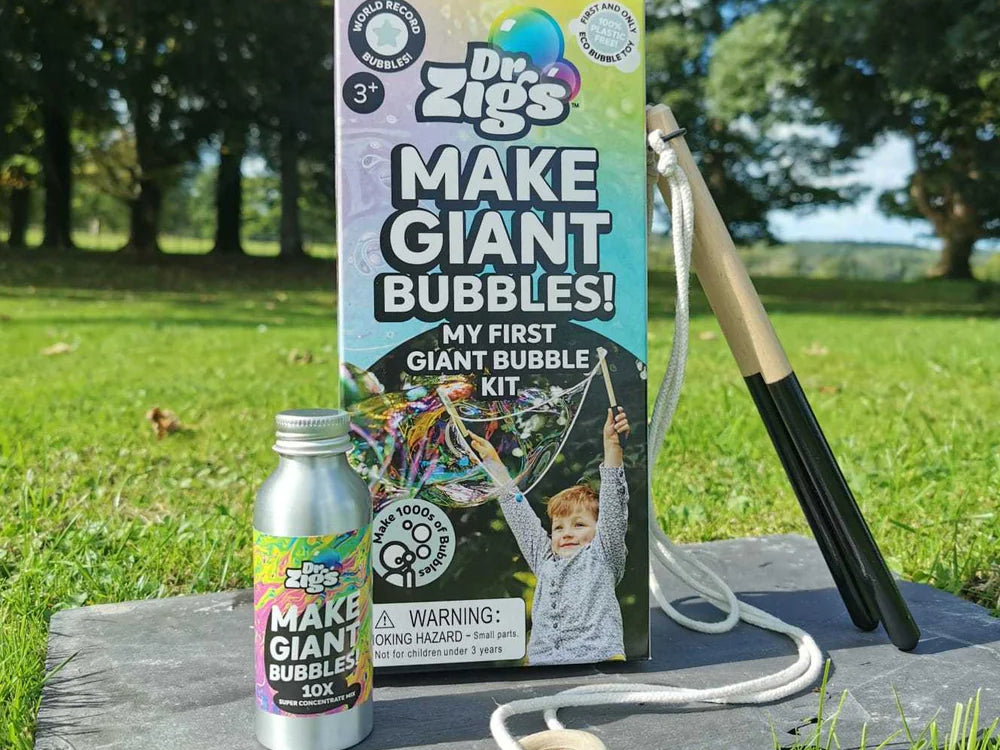 Dr. Zigs bubble kit with bottle and wand on a wooden board outdoors