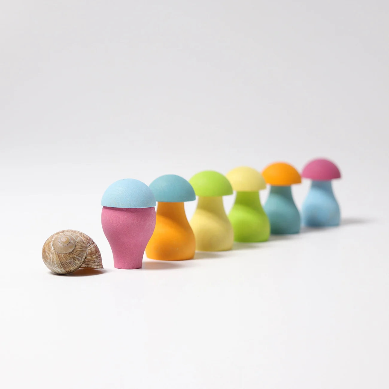Colorful mushroom-shaped objects with a shell on a white background