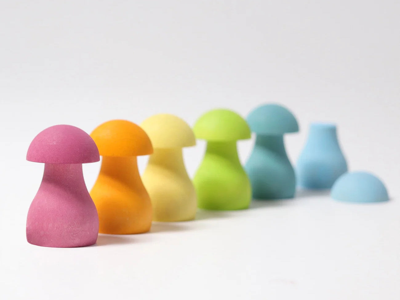 Colorful mushroom-shaped objects on a white background