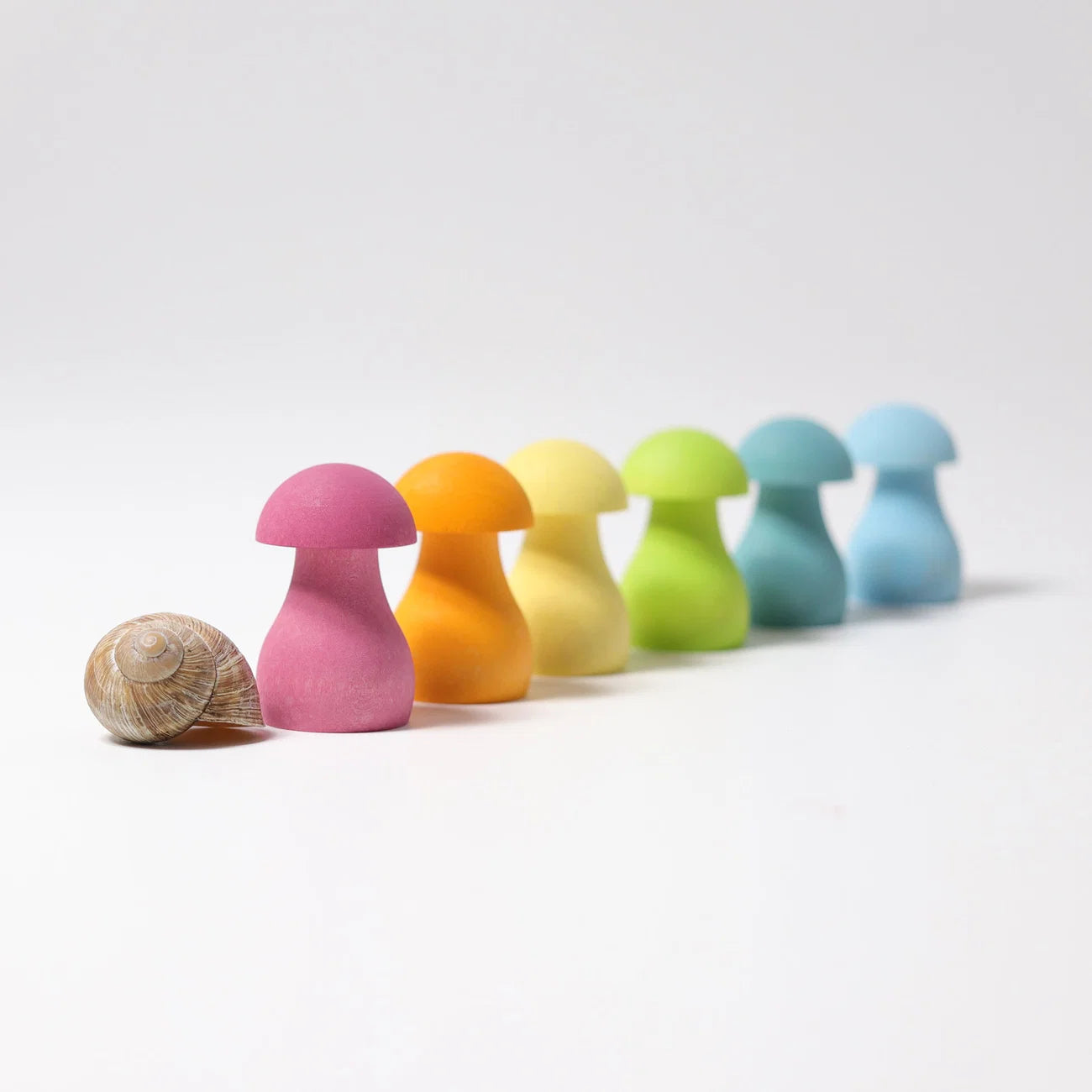 Colorful mushroom-shaped objects with a shell on a white background