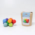 Colorful ball toy next to its packaging on a white background