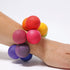 Colorful stress ball on a wrist against a white background